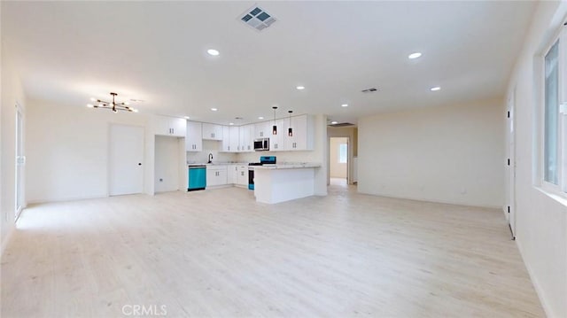 unfurnished living room with light wood-type flooring, visible vents, a chandelier, and recessed lighting