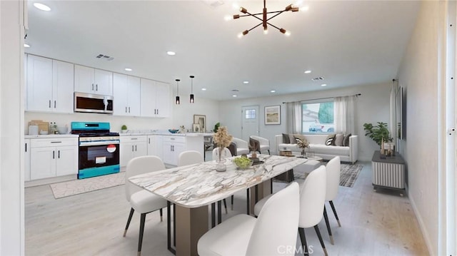 dining area featuring light wood finished floors, visible vents, a notable chandelier, and recessed lighting