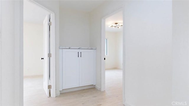 corridor featuring light wood-style floors