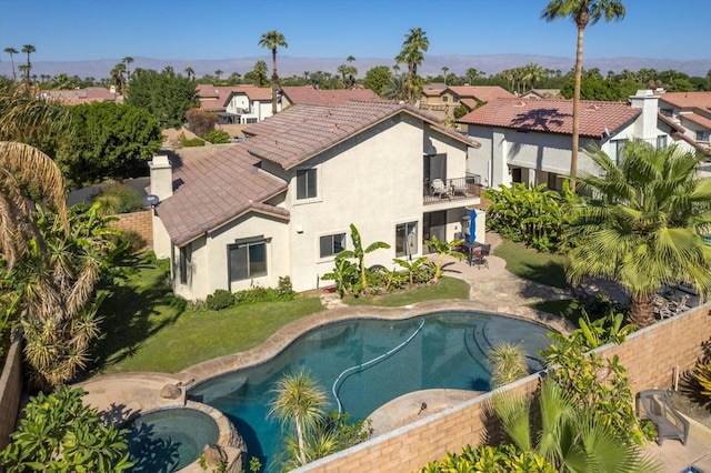 view of swimming pool featuring a yard, a patio, and an in ground hot tub