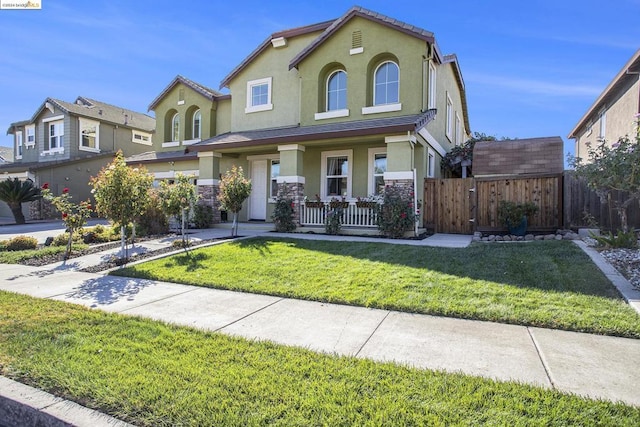 view of front of property with covered porch and a front lawn