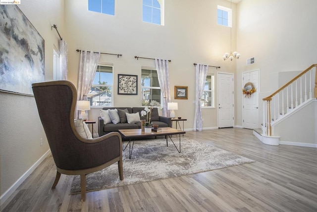 living room with hardwood / wood-style floors and an inviting chandelier