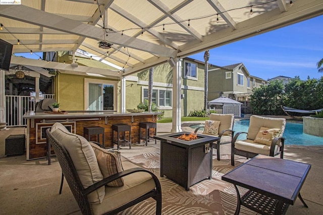 view of patio / terrace with a bar and a fire pit