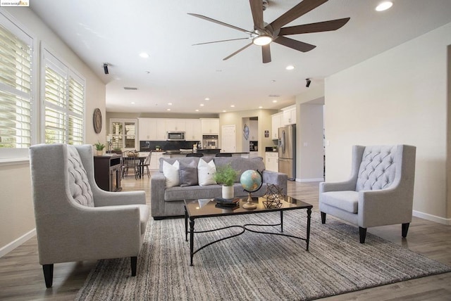 living room featuring hardwood / wood-style flooring and ceiling fan