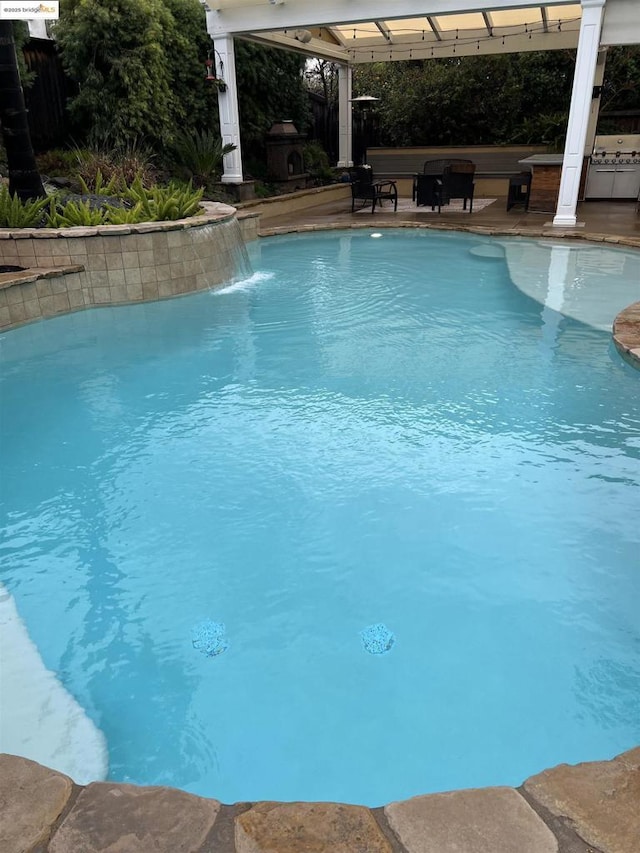 view of pool featuring pool water feature