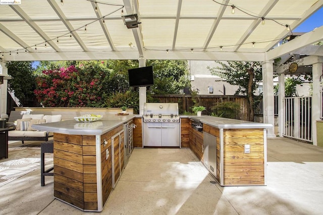 view of patio / terrace with area for grilling, a pergola, an outdoor bar, and an outdoor kitchen