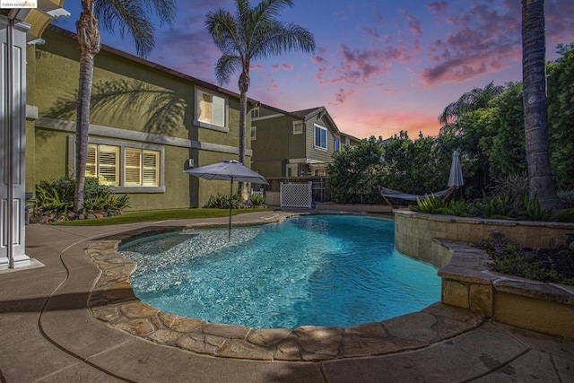 view of pool at dusk