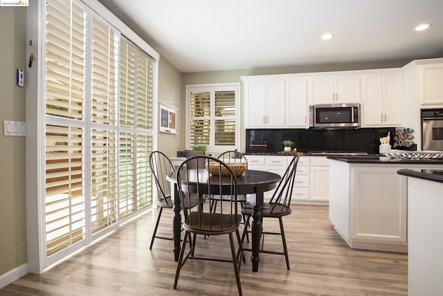 kitchen with white cabinetry, a wealth of natural light, tasteful backsplash, and stainless steel appliances