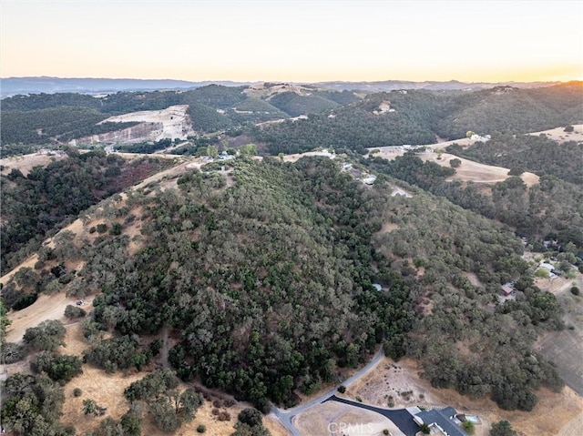 aerial view at dusk featuring a mountain view