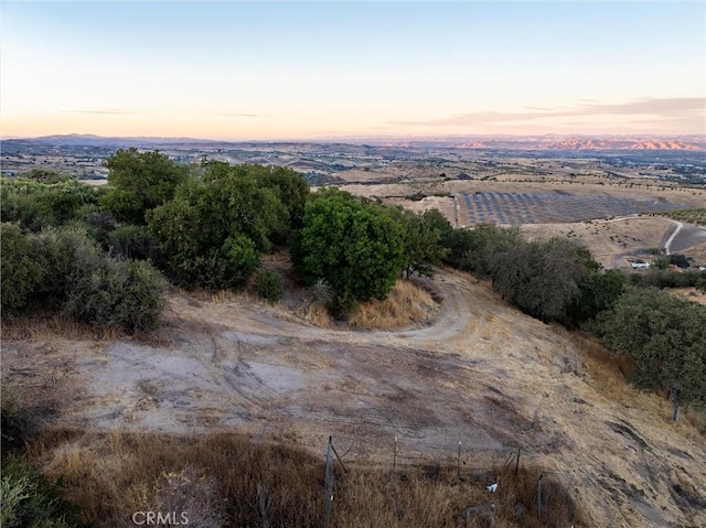 aerial view at dusk featuring a rural view