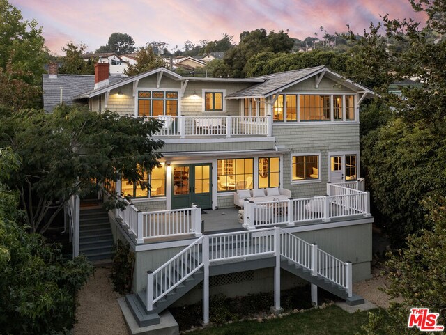 view of back house at dusk