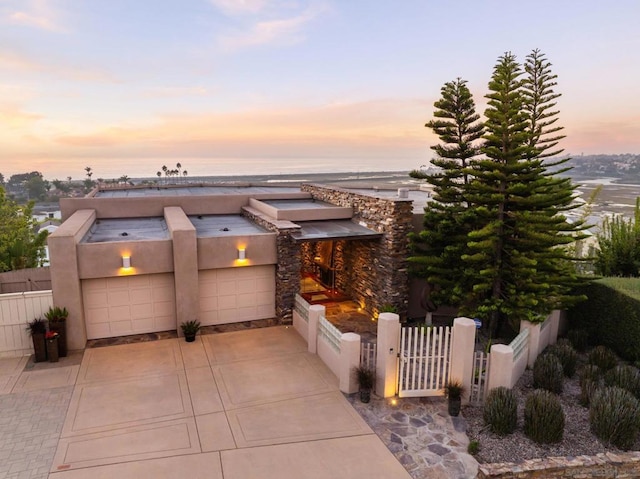 view of front facade with a garage and a water view