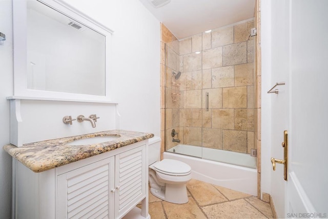 full bathroom with toilet, vanity, and shower / bath combination with glass door