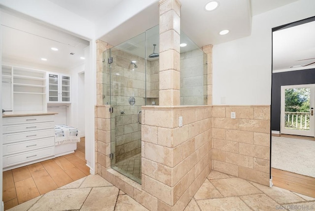 bathroom with an enclosed shower and hardwood / wood-style flooring