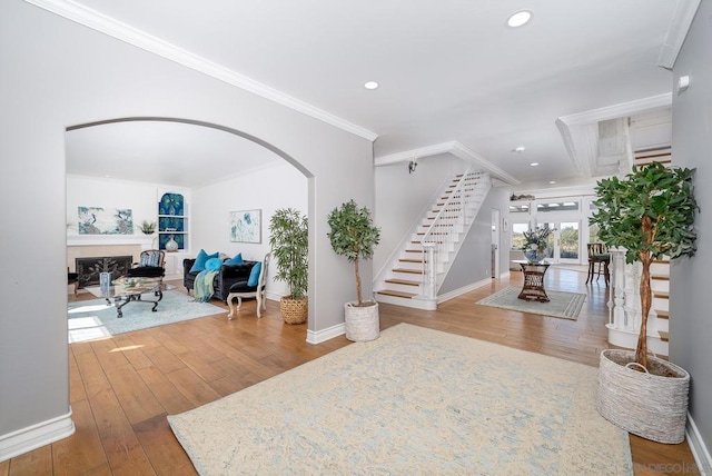 entrance foyer featuring crown molding and light hardwood / wood-style floors