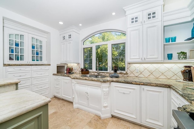 kitchen featuring white cabinetry and sink