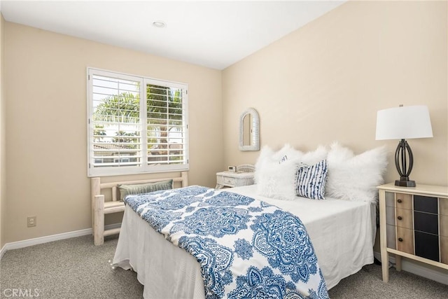 bedroom featuring baseboards and carpet