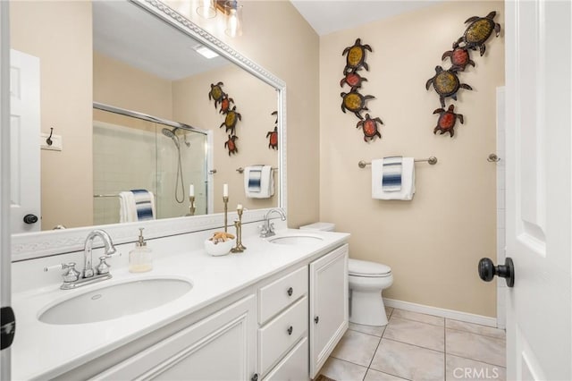 bathroom with a sink, toilet, a shower stall, and double vanity