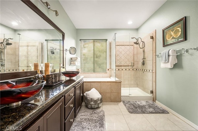 bathroom with a shower stall, tile patterned flooring, and vanity