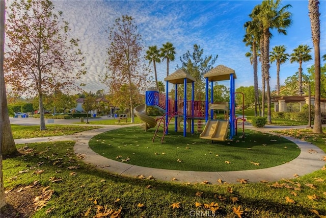 community jungle gym featuring a yard