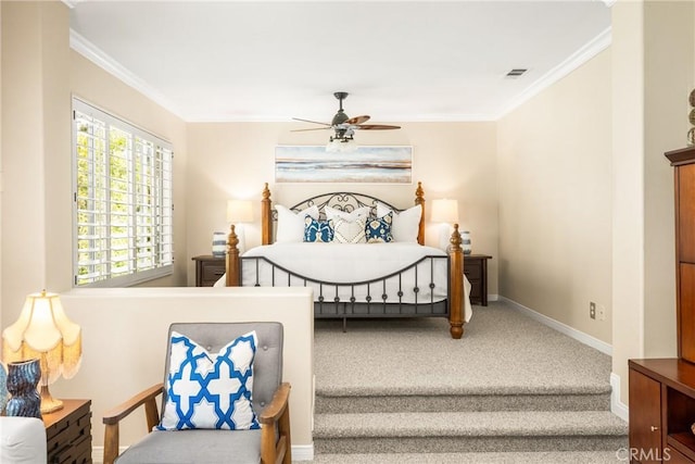 carpeted bedroom featuring visible vents, baseboards, ornamental molding, and ceiling fan