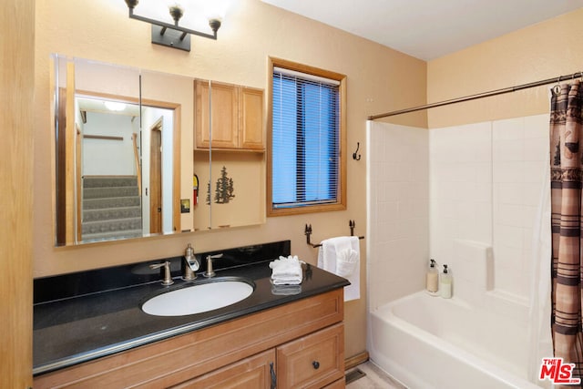 bathroom featuring vanity and shower / bath combo