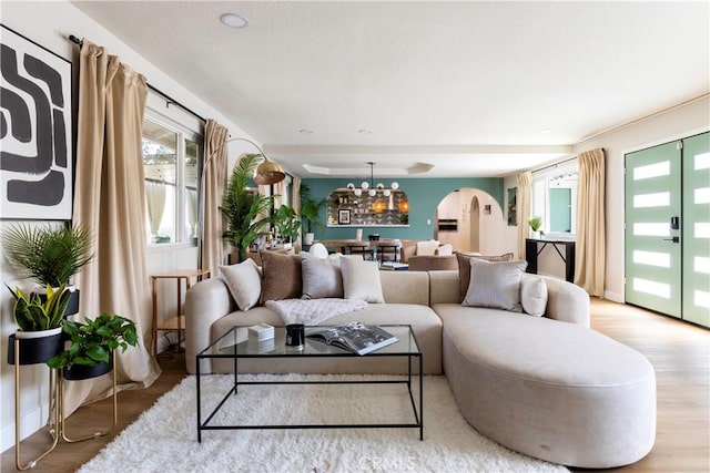 living room with hardwood / wood-style flooring and an inviting chandelier