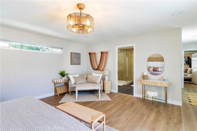 bedroom with wood-type flooring and connected bathroom