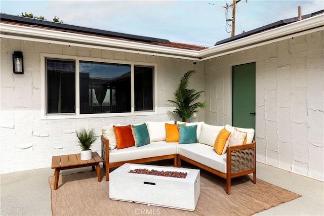 view of patio / terrace featuring an outdoor living space with a fire pit