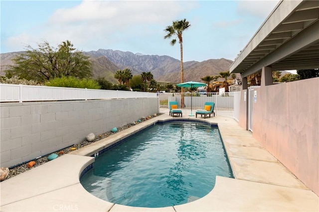 view of pool with a mountain view and a patio area