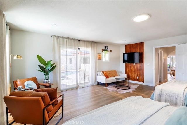 bedroom featuring access to exterior and light hardwood / wood-style flooring