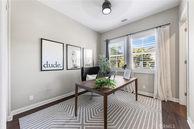 home office with dark hardwood / wood-style flooring and ceiling fan