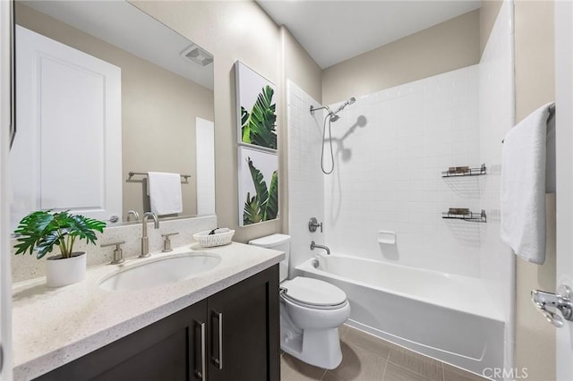 full bathroom with tile patterned flooring, vanity, toilet, and tiled shower / bath