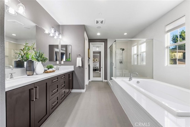 bathroom with vanity and independent shower and bath