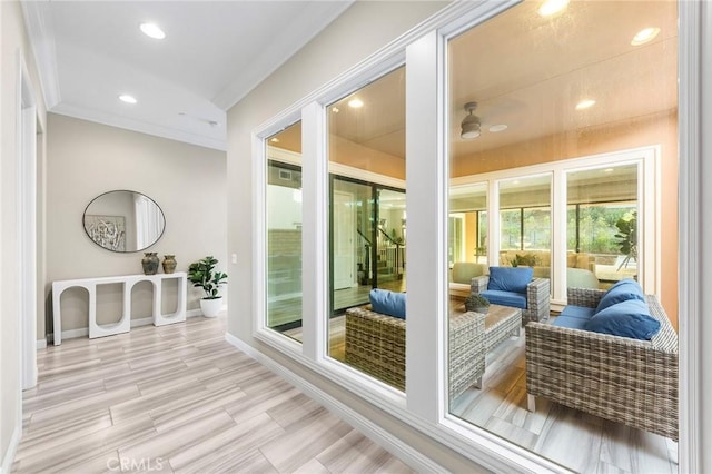 doorway to outside with light hardwood / wood-style flooring, ceiling fan, and crown molding