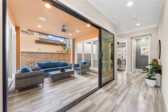 entryway featuring ceiling fan, light hardwood / wood-style floors, and ornamental molding