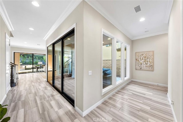 hallway featuring light hardwood / wood-style floors and crown molding