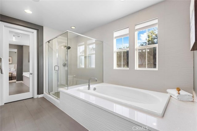 bathroom featuring separate shower and tub