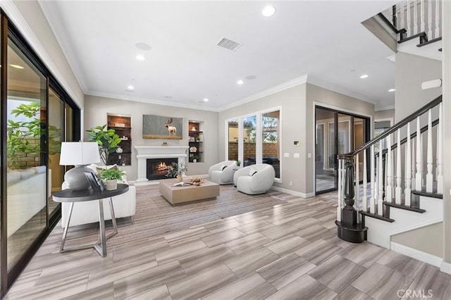 living room with light hardwood / wood-style floors and ornamental molding