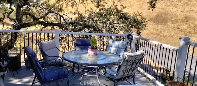 wooden deck with outdoor dining area