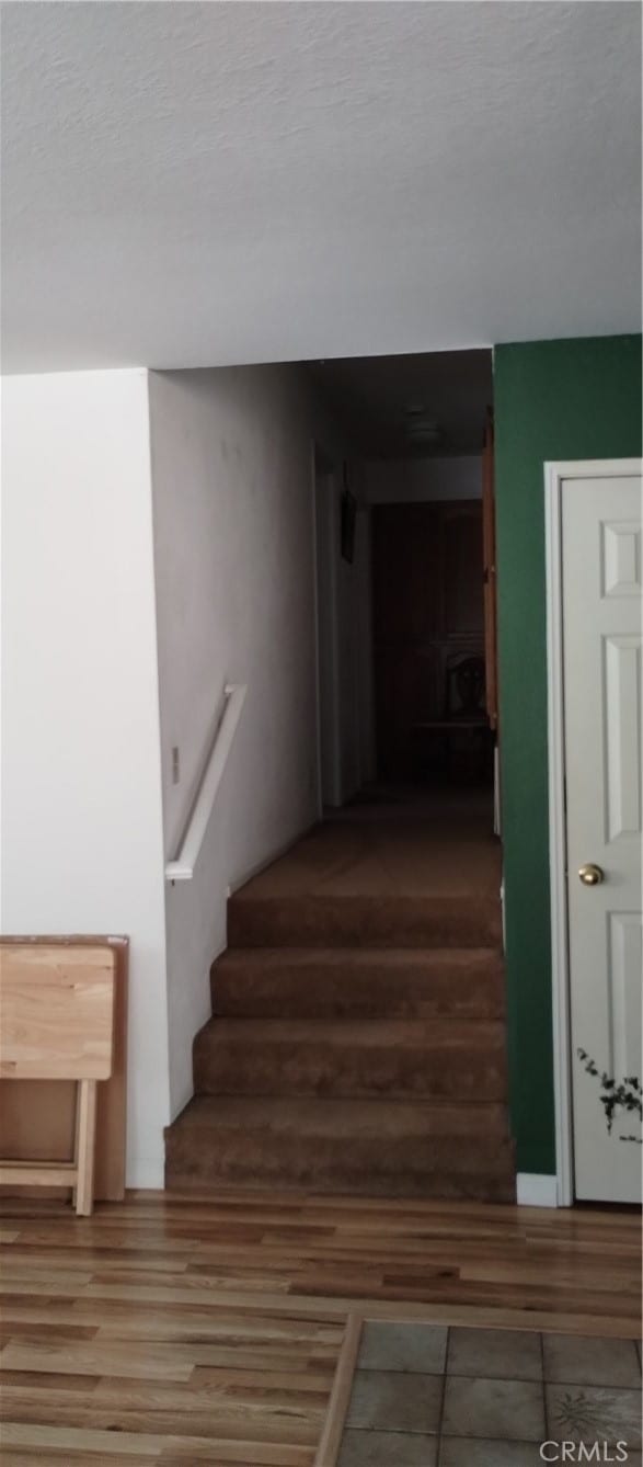 stairway featuring hardwood / wood-style flooring