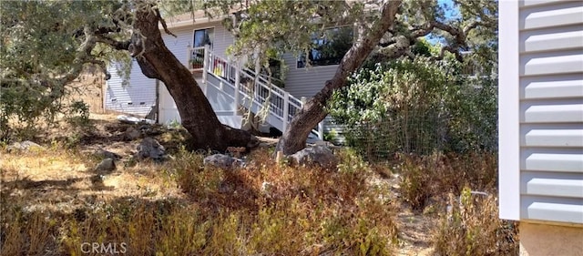 view of side of home featuring stairs