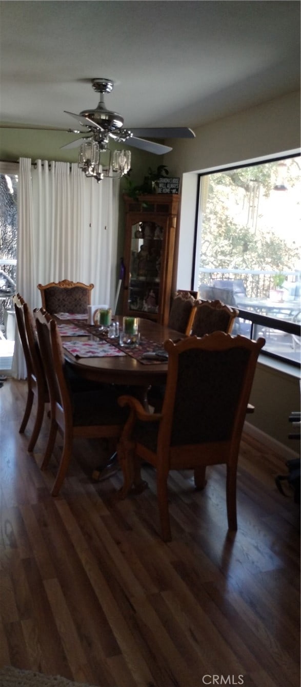 dining space with dark wood-type flooring and ceiling fan