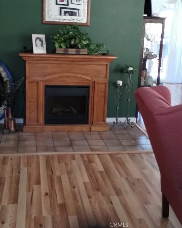 living area with light wood finished floors and a fireplace