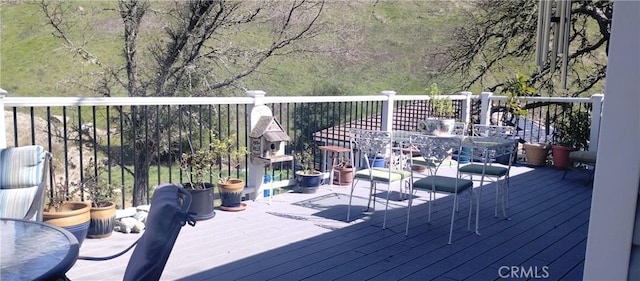 wooden deck featuring outdoor dining space