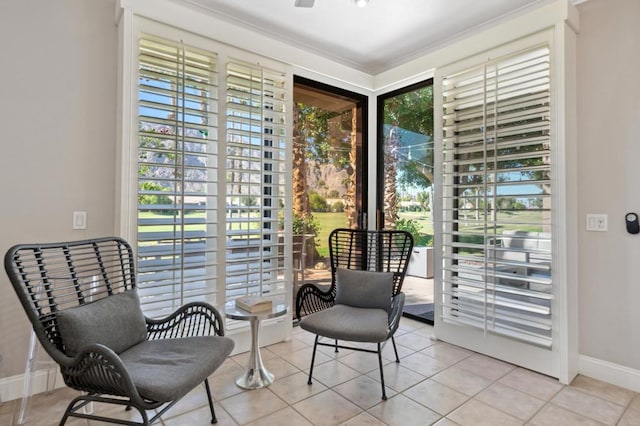 sitting room with crown molding, plenty of natural light, and light tile patterned floors