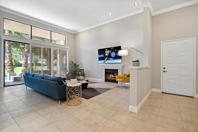 living room featuring ornamental molding, a high ceiling, and light tile patterned floors