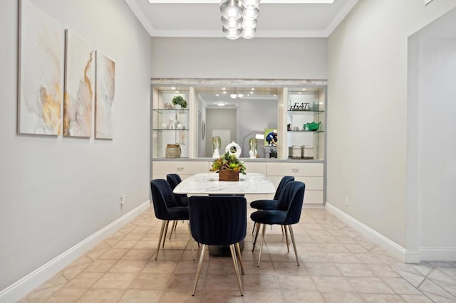 dining space featuring crown molding and light tile patterned floors