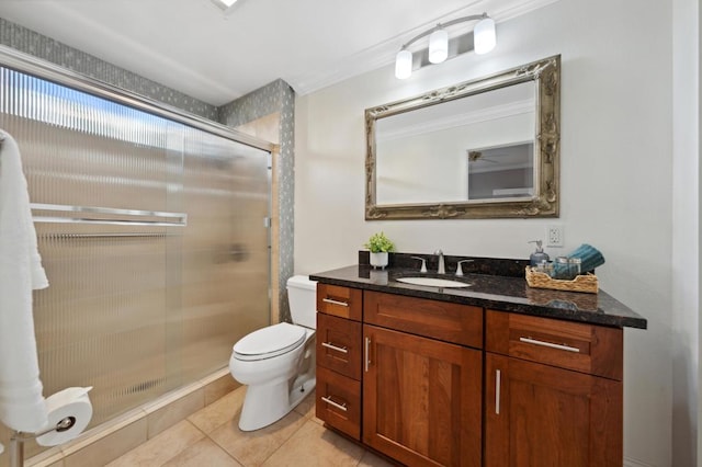 bathroom featuring a shower with door, toilet, tile patterned floors, vanity, and ornamental molding