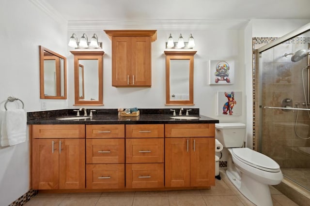 bathroom with toilet, a shower with shower door, vanity, and crown molding